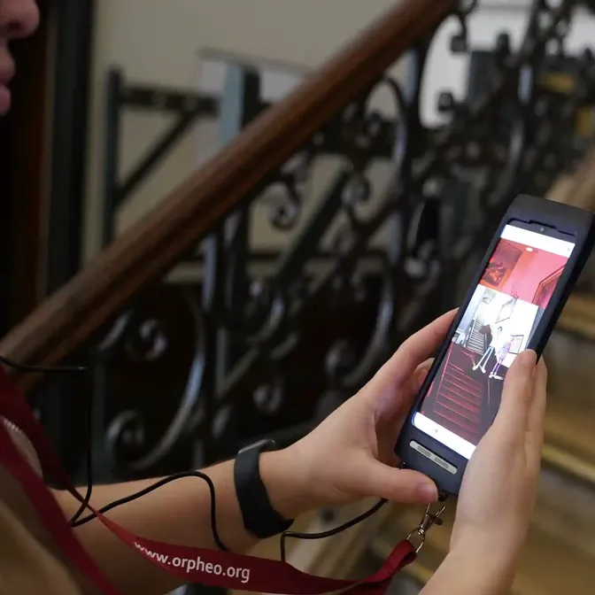 Bezoeker met de Orpheo Touch multimediaguide in het stadhuis van Brussel