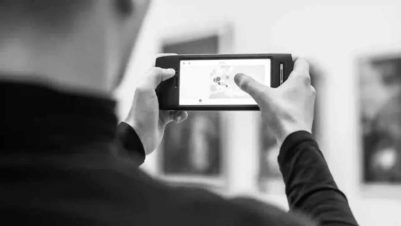 Bezoeker bekijkt een museumapp op zijn smartphone